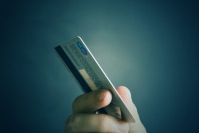 credit card in hand to pay on a freelance translation website